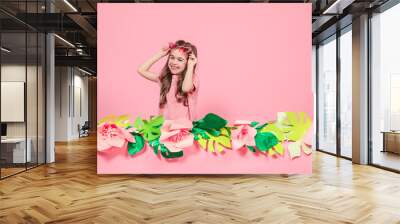 Portrait of a little girl with sunglasses on a pink background Wall mural