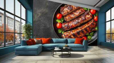 Delicious grilled ribs served on a black plate with fresh tomatoes and parsley, perfect for a hearty meal. Wall mural