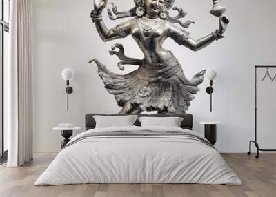 A silver statue of a Hindu deity in a dancing pose, holding a lamp in one hand and with a serene expression. Wall mural