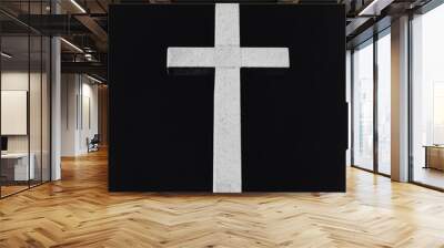 A simple white cross against a black background. Wall mural