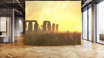 Ancient stone monument at sunrise with hazy golden sky and grass in foreground. Wall mural