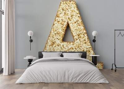 Golden glitter letter A isolated on gray background. Wall mural