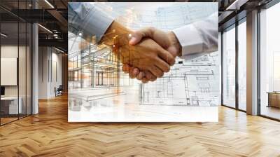 Two professionals shaking hands over a backdrop of architectural plans and cityscape, signifying a deal or partnership in construction Wall mural