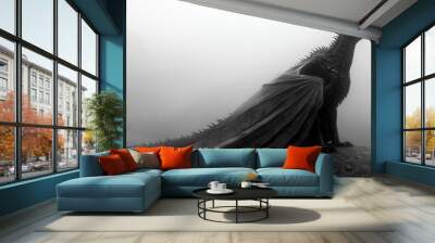 Black dragon perched on a rock in a misty landscape. Wall mural