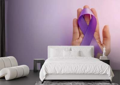 health and treatment concept - womand hand holding purple cancer awareness ribbon. Wall mural