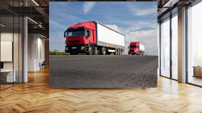 Two red trucks on road Wall mural