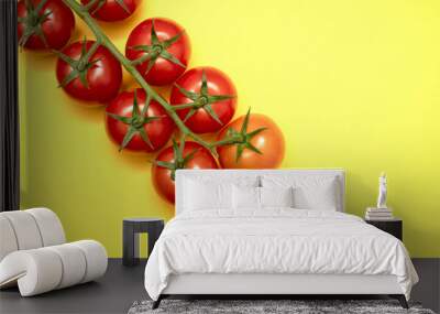 Red cherry tomatoes with green branch on yellow background	 Wall mural