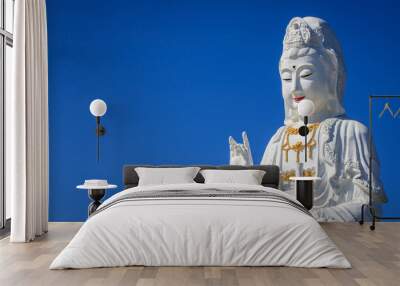 Big guanyin statue with blue sky background. Wall mural