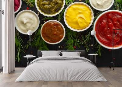 Different types of sauces in bowls with seasonings banner, rosemary and dill, thyme and and peppercorns, top view, copy space Wall mural