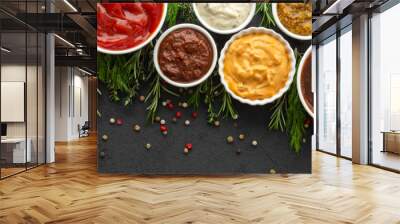 Different types of sauces in bowls with seasonings banner, rosemary and dill, thyme and and peppercorns, top view, copy space Wall mural