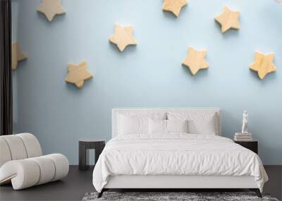 Natural wooden stars and rowan branches on a blue background, Christmas background, Merry Christmas and Happy New Year banner, top view, copy space Wall mural