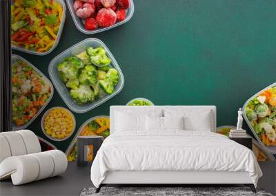 Preparing food for the winter, freezing fresh vegetables in the summer in the refrigerator, various frozen vegetables in plastic dishes on a green background Wall mural