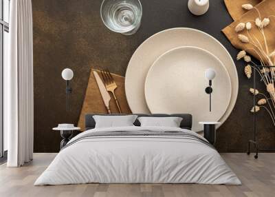 table setting, empty plate with napkin and cutlery on a brown background, top view of the served tab Wall mural