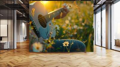 Close-up of a person playing guitar in a field of flowers with warm sunlight, capturing a peaceful and tranquil outdoor moment. Wall mural