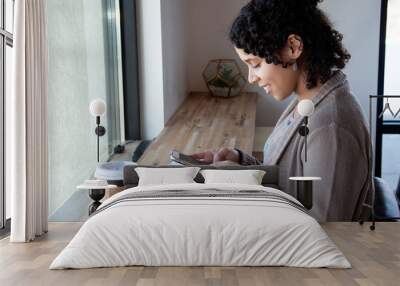 woman uses her phone to look up information for her bible study  Wall mural