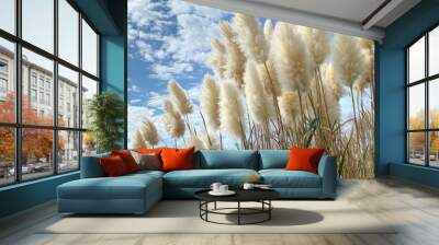 Pampas grass sways gently in breeze under bright blue sky, creating serene and aesthetic landscape. fluffy white plumes contrast beautifully with vibrant greenery, evoking sense of tranquility Wall mural