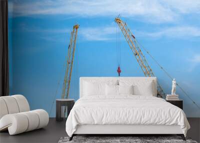 Construction crane on blue sky background Wall mural