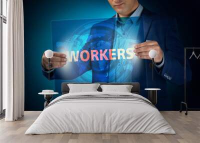 Businessman holding a transparent screen with an inscription a w Wall mural