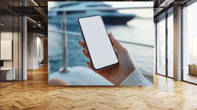 woman sitting on yacht holding mobile phone Wall mural