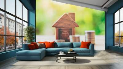 Coins placed on the wood is ladder and House placed on the wood. planning savings money of coins to buy a home concept, concept property mortgage and investment or saving for a buy house. Wall mural