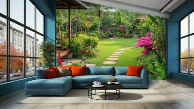 A serene garden at a resort in Phang Nga, with tropical flowers and plants creating a tranquil atmosphere. Wall mural