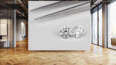 Carat size diamonds compared with tweezers on white isolated Wall mural