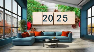 Cubes marked as 2025 set against pine branches and holiday ornaments symbolize fresh starts and ambitious resolutions for the New Year Wall mural