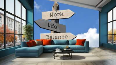 Work, life, balance - wooden signpost with three arrows, sky with clouds Wall mural