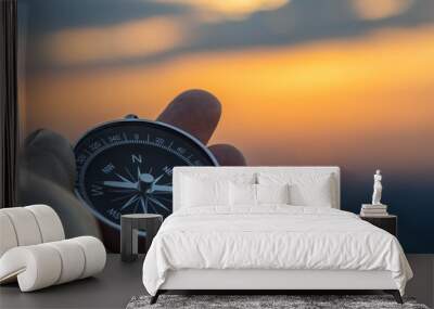 compass in hand with sunset sky on the background Wall mural