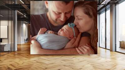 The mother and father embracing   their daughter Wall mural