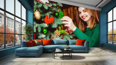 young and beautiful woman in cute green sweater decorated Christ Wall mural