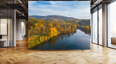 Fojtka water reservoir surrounded by vibrant colored forest at autumn time. Aerial view from drone. Wall mural