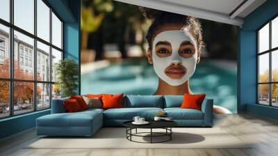 Afro-american girl in a sheet facial mask on the pool background. Spa resort and cosmetic treatment concept. Lifestyle portrait for poster, commercial, presentation  Wall mural