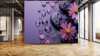 black spa stones with flowers on a purple background. stone massage, relax and self-care concept. fl Wall mural