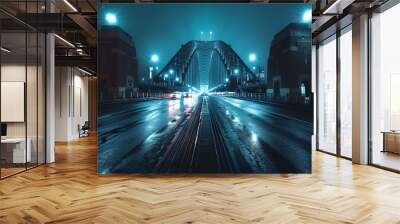 A bridge is lit up at night with cars driving on it Wall mural