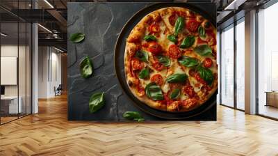 A pizza with basil and tomatoes on top of it Wall mural