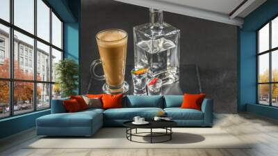 aromatic coffee latte with vodka in a decanter and two glasses decorated with peppers, whole black stone plate Wall mural