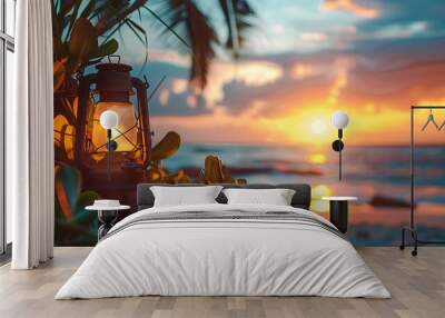 A camping lamp and garden plants against the backdrop of a beach sunset Wall mural