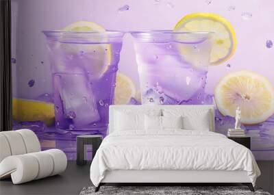 Two purple lemonade cups with a wedge of lemon in them Wall mural