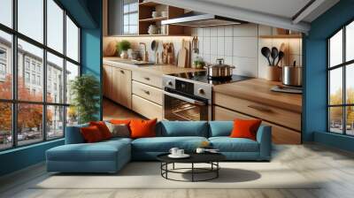 Induction stove, oven and range hood on modern kitchen with wooden furniture. Stainless pan on glass ceramic hob. Cooking food on electric cooker at home. Household appliance. Apartment interior Wall mural