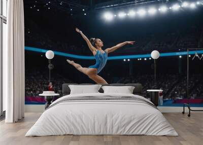 Professional gymnast woman performing an acrobatic trick. Female athlete displaying her flexibility, balance, and strength while executing a gymnastics routine during sport competition or championship Wall mural