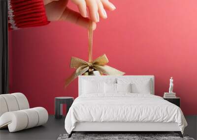 Christmas atmosphere, golden bell in hand, joy overflow Wall mural