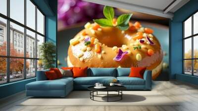 A beautifully decorated donut with vibrant toppings and a fresh mint leaf. Wall mural