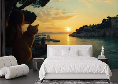 A serene sunset scene with a girl and an orange cat by the water's edge. Wall mural