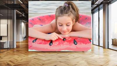 Adorable little girl with large inflatable rubber circle during beach vacation Wall mural