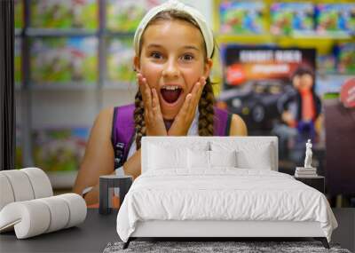 Cute girl surprised in a toy store Wall mural