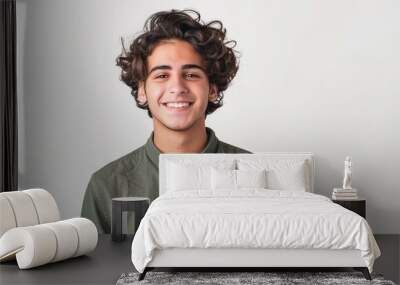 Happy Jewish young man in casual shirt smiling confidently on white background, portrait of a happy teenage boy with curly short hair looking at the camera. Wall mural