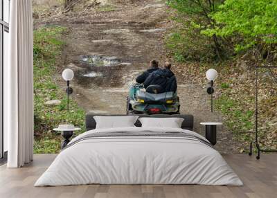 two men riding ATV in mountains Wall mural