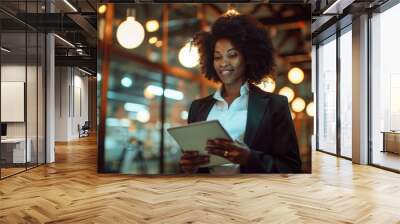 Working smart, working hard. Shot of a young african american businesswoman using a digital tablet at office. Happy, business and a corporate employee. Wall mural