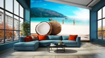 Close up of coconut on wood table over summer beach background Wall mural